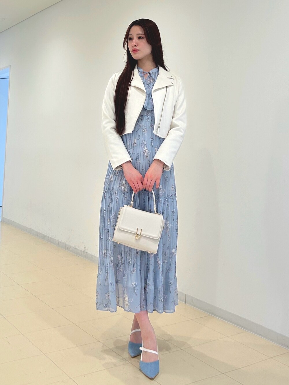 ブルー系のワンピース、ホワイト系のハンドバッグ、ホワイト系のパンプスを着用したレディースの春コーディネートの3枚目の写真