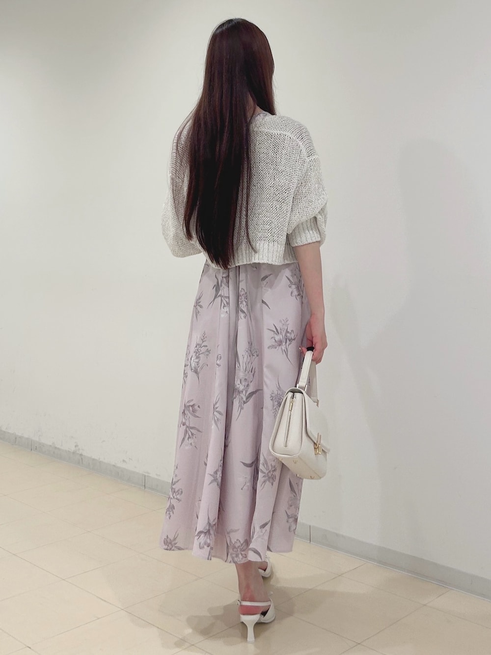 ピンク系のワンピース、ホワイト系のパンプス、ホワイト系のハンドバッグを着用したレディースの夏コーディネートの4枚目の写真