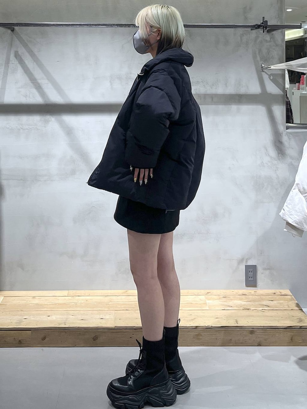 グレー系のニット/セーター、ブラック系のブルゾン、ブラック系のスカートを着用したレディースの冬コーディネートの4枚目の写真