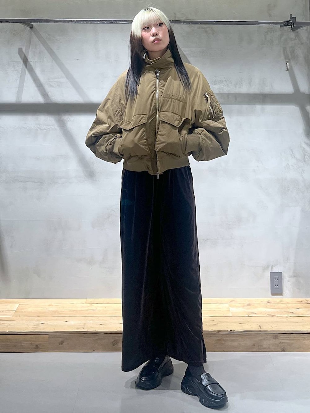 ブラック系のローファー、ブラウン系のその他パンツ、グリーン系のブルゾンを着用したレディースの秋コーディネートの2枚目の写真