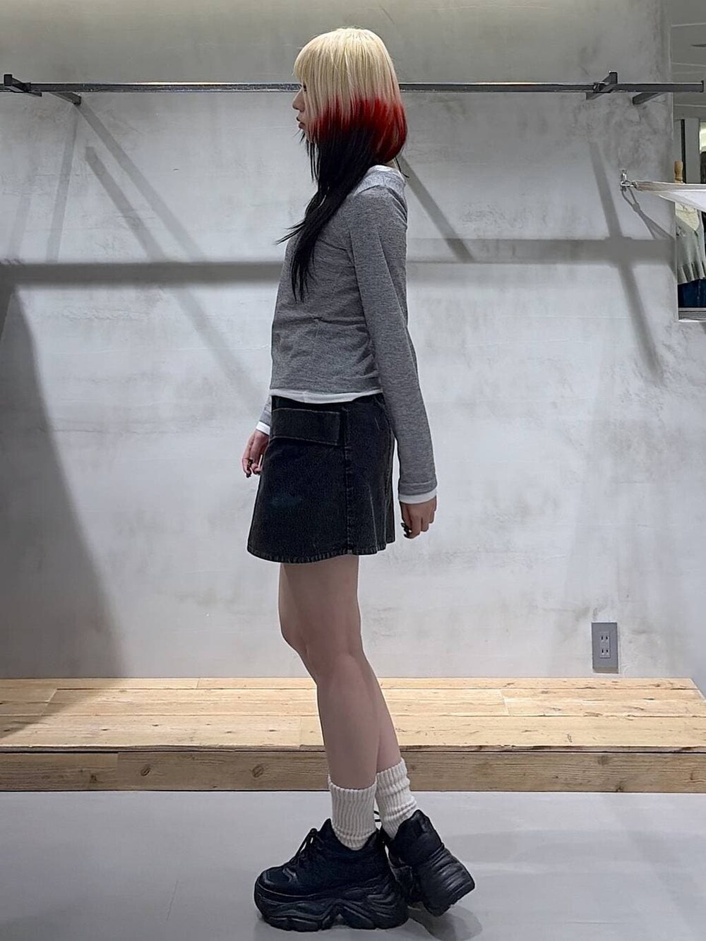 ブラック系のスニーカー、グレー系のTシャツ/カットソー、ブラック系のスカートを着用したレディースの春コーディネートの5枚目の写真