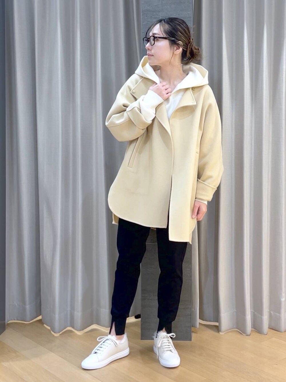 ベージュ系のノーカラージャケット、ブラック系のその他パンツ、ホワイト系のスニーカーを着用したレディースの冬コーディネートの2枚目の写真
