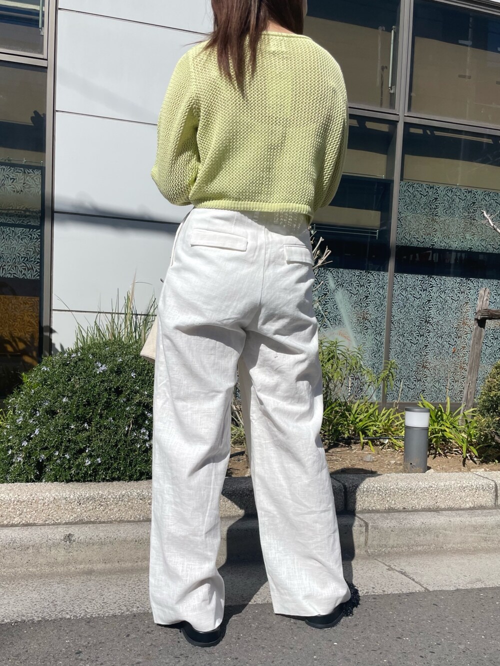 グリーン系のカーディガン/ボレロ、ホワイト系のその他パンツ、グリーン系のトートバッグを着用したレディースの春コーディネートの6枚目の写真