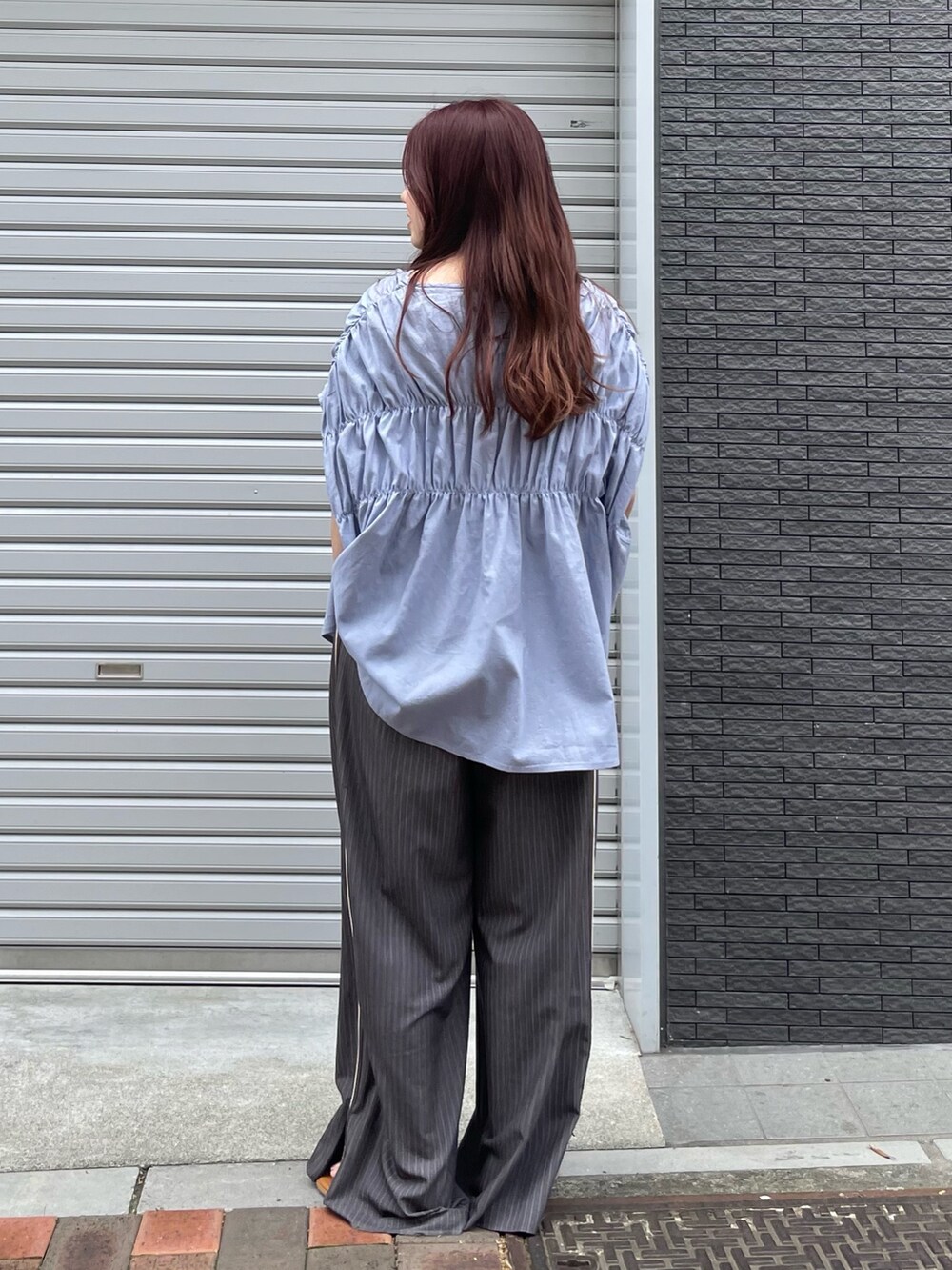 ブルー系のシャツ/ブラウス、グレー系のその他パンツを着用したレディースの夏コーディネートの3枚目の写真