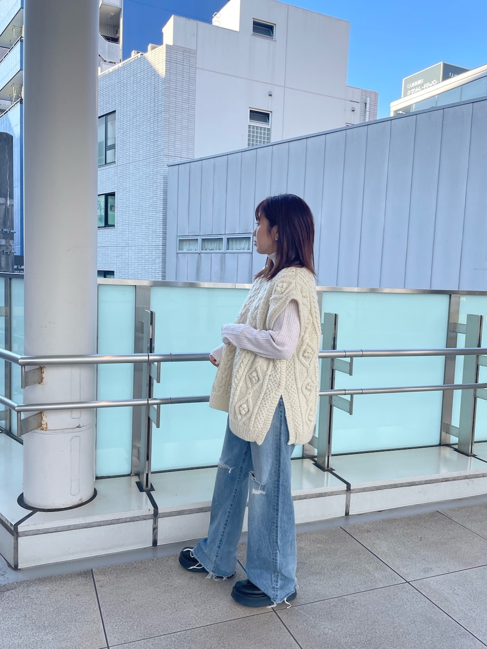 ホワイト系のニット/セーター、ホワイト系のニット/セーター、ブルー系のデニムパンツを着用したレディースの秋コーディネートの2枚目の写真