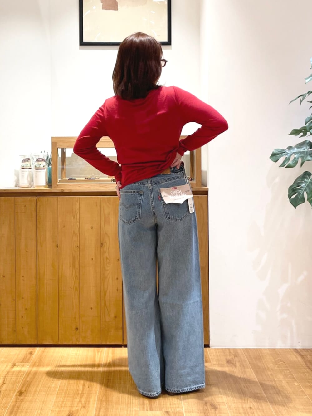 ブルー系のデニムパンツ、その他のサンダル、レッド系のカーディガン/ボレロを着用したレディースの夏コーディネートの3枚目の写真