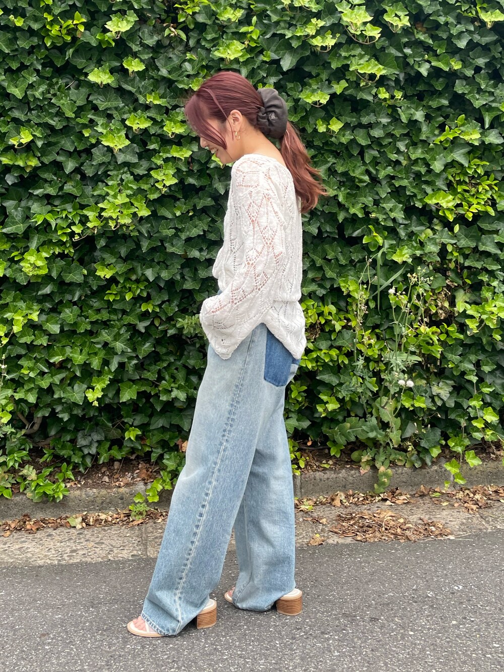 ホワイト系のニット/セーター、ブルー系のデニムパンツ、ホワイト系のサンダルを着用したレディースの夏コーディネートの2枚目の写真