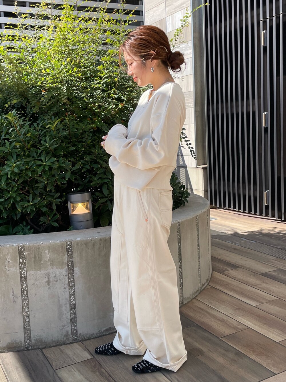 ホワイト系のTシャツ/カットソー、ホワイト系のデニムパンツ、ブラック系のパンプスを着用したレディースの秋コーディネートの3枚目の写真