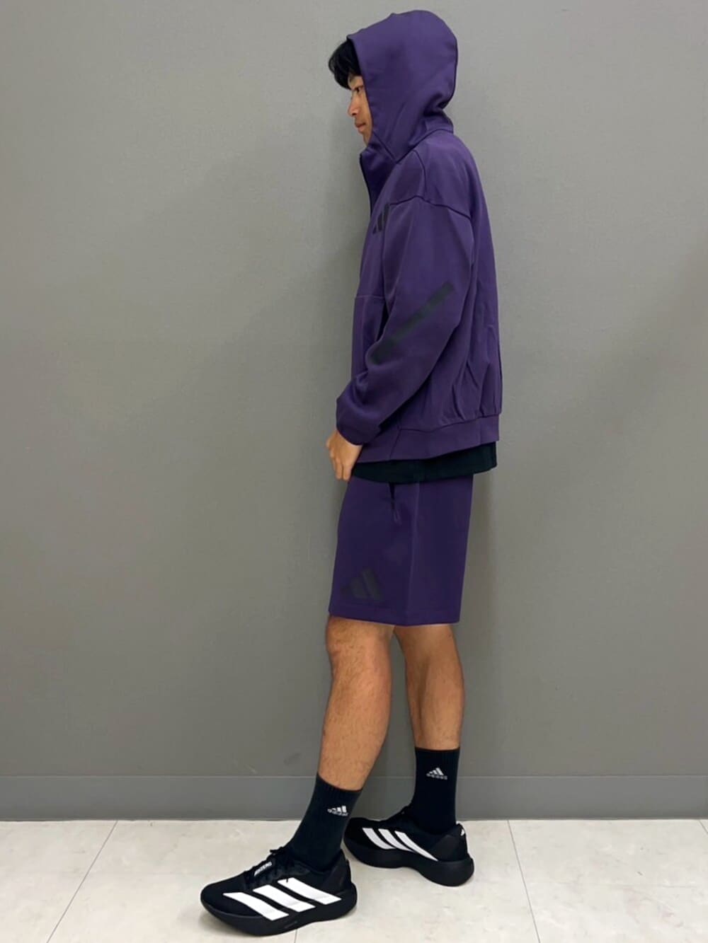 パープル系のパーカー、ブラック系のTシャツ/カットソー、パープル系のパンツを着用したメンズの秋コーディネートの3枚目の写真