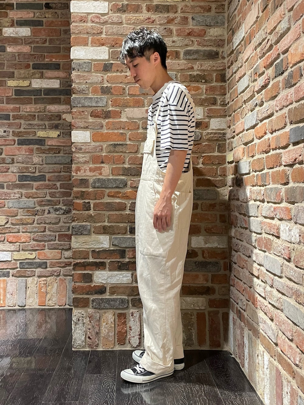 ホワイト系のTシャツ/カットソー、ホワイト系のサロペット/オーバーオール、ブラック系のスニーカーを着用したメンズの夏コーディネートの2枚目の写真