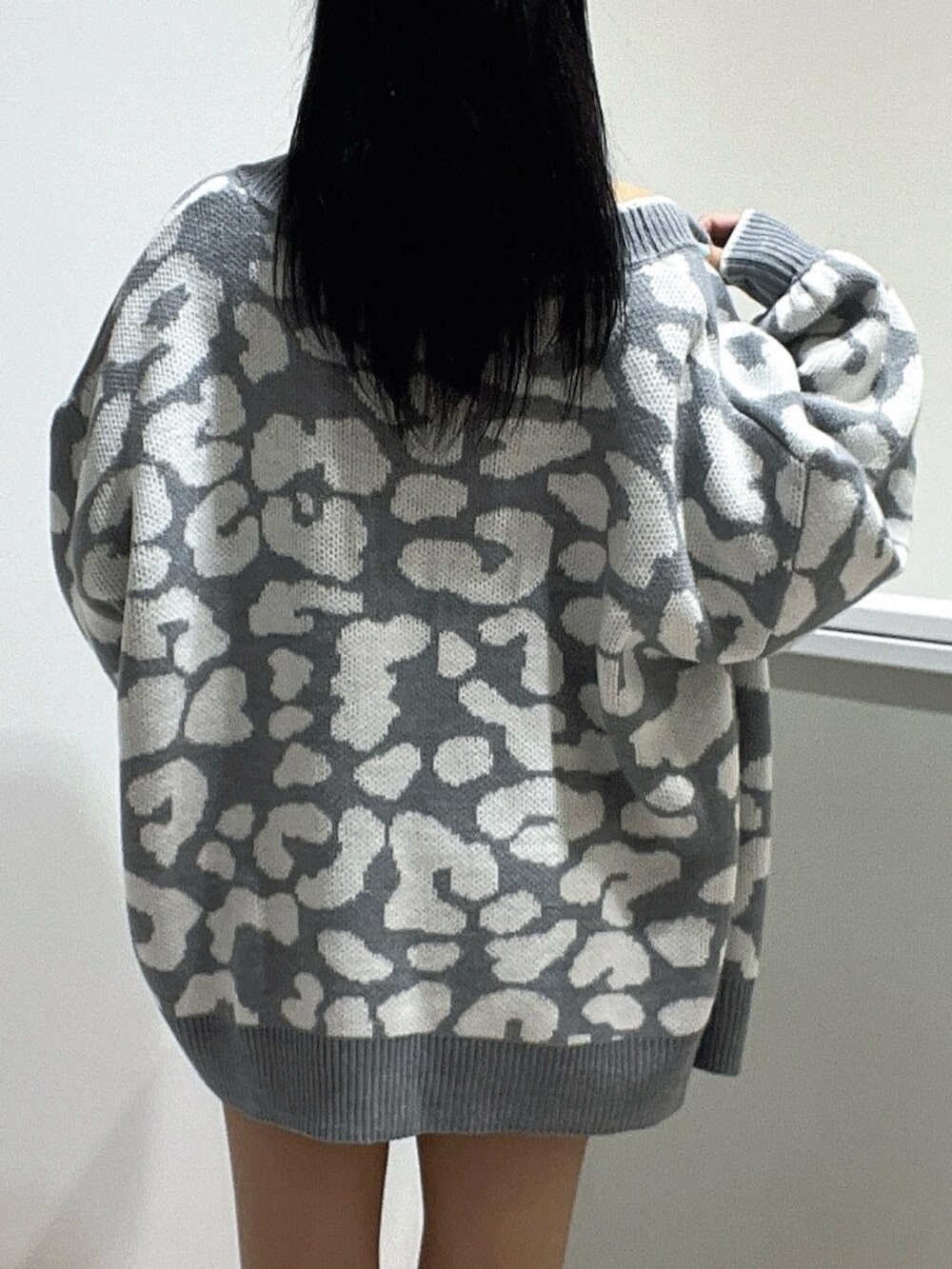 ブルー系のワンピース、ホワイト系のブーツ、グレー系のカーディガン/ボレロを着用したレディースの春コーディネートの5枚目の写真