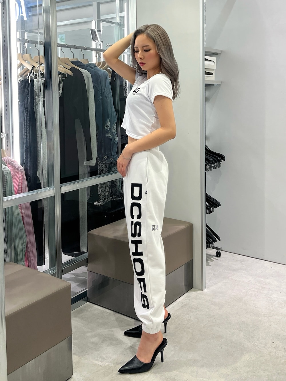 ホワイト系のTシャツ/カットソー、ホワイト系のスウェットパンツ、ブラック系のパンプスを着用したレディースの春コーディネートの2枚目の写真