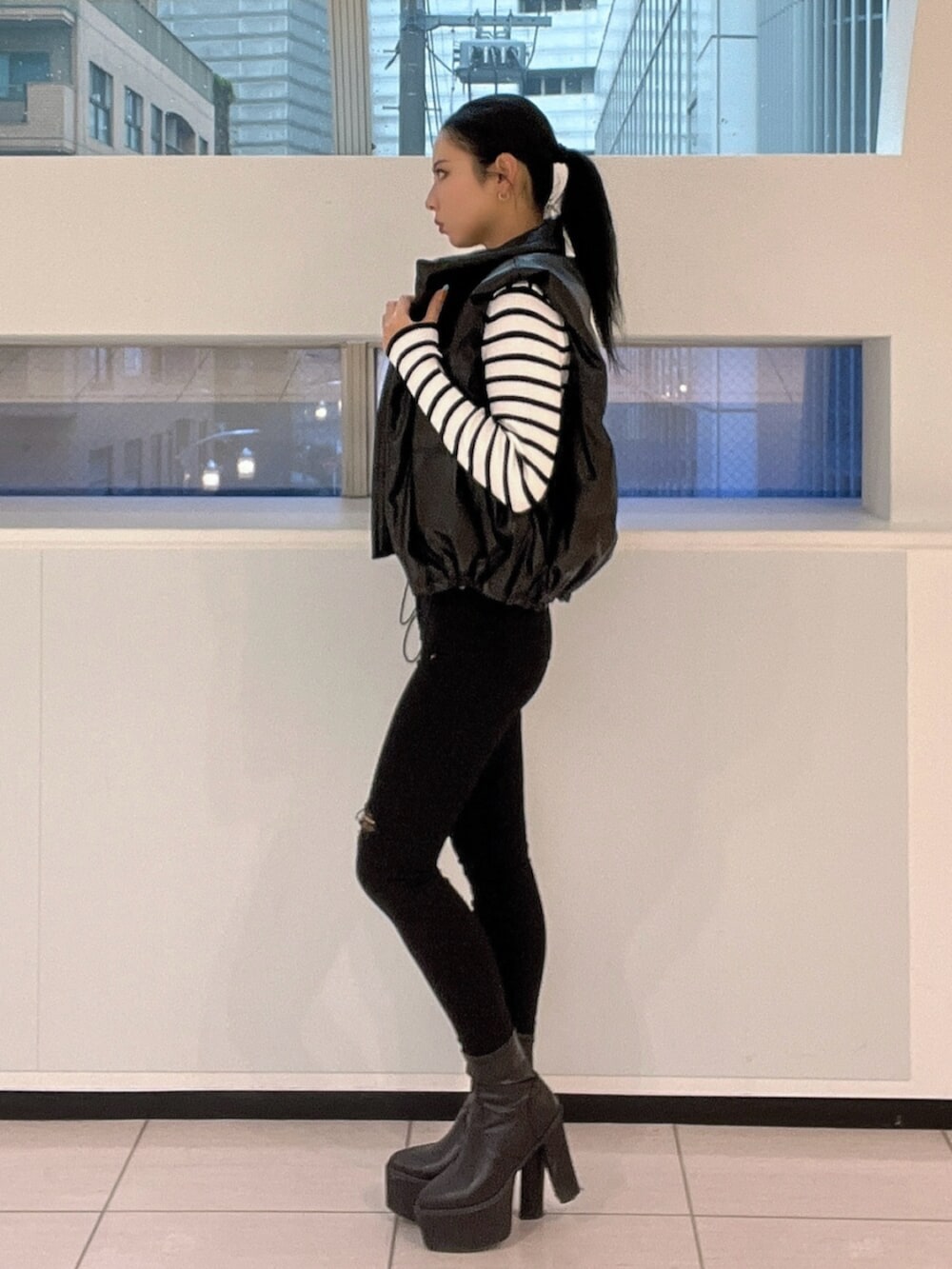 ブラック系のブーツ、その他のニット/セーター、ブラック系のダウンジャケット/コートを着用したレディースの秋コーディネートの3枚目の写真