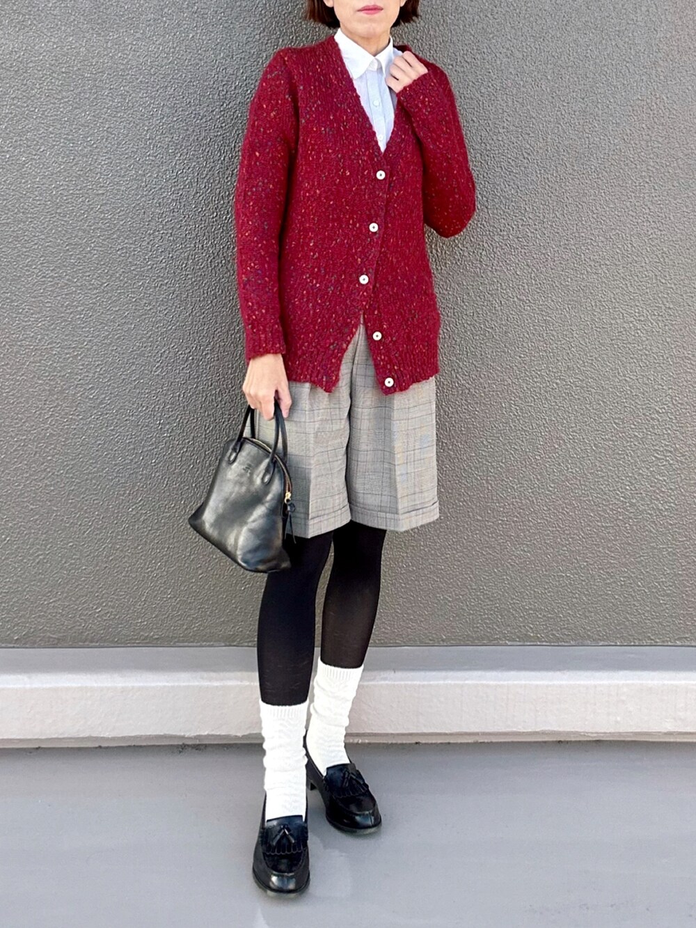 レッド系のカーディガン/ボレロ、ブラウン系のその他パンツ、ブラック系のボストンバッグを着用したレディースの秋コーディネートの3枚目の写真