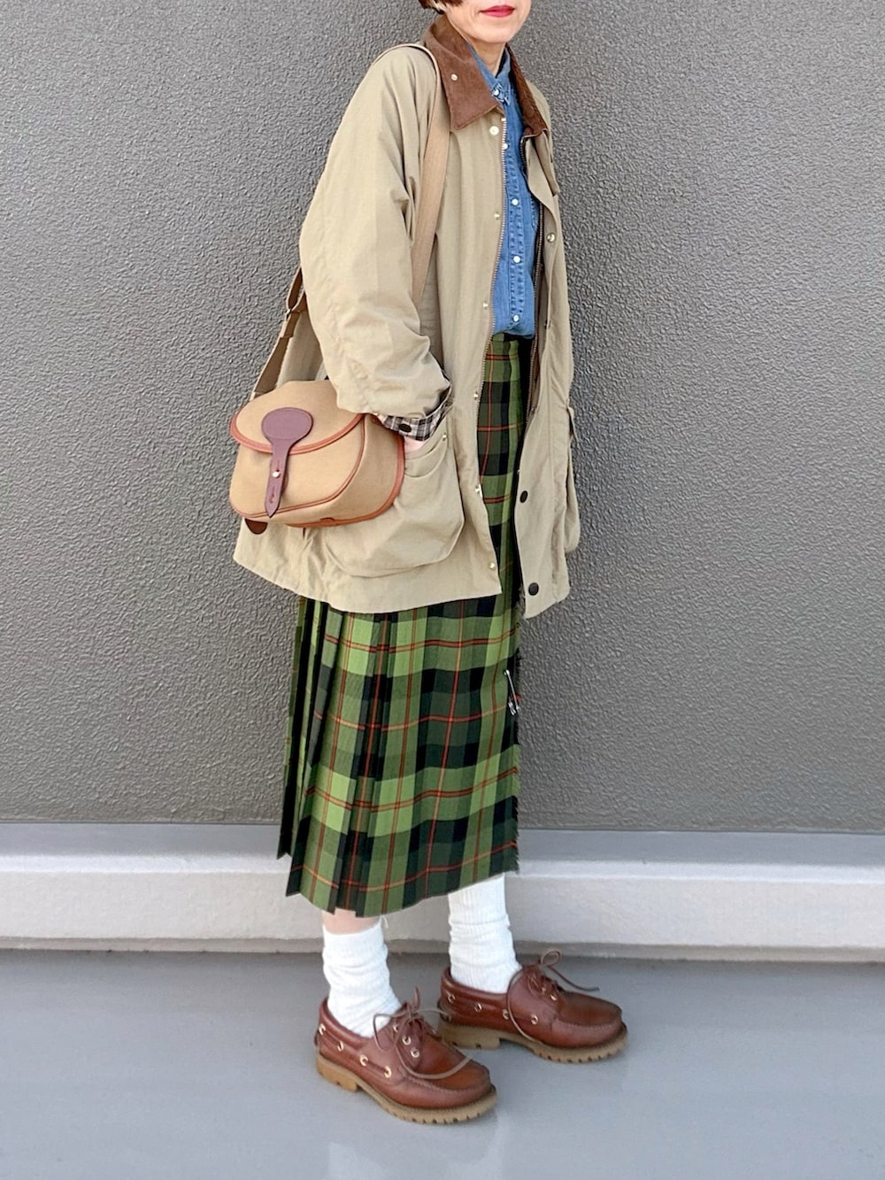 ベージュ系のブルゾン、グリーン系のスカート、グリーン系のショルダーバッグを着用したレディースの春コーディネートの3枚目の写真