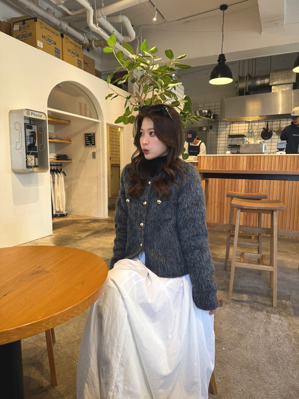 ホワイト系のスカート、グレー系のジャケット/アウター、ブラック系のブーツを着用したレディースの冬コーディネートの4枚目の写真