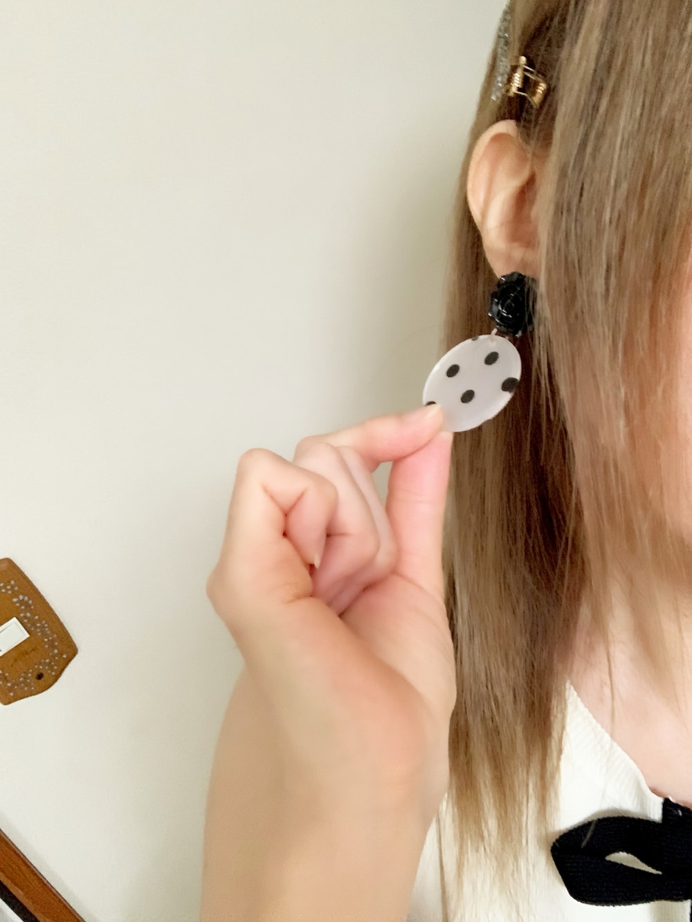 ブラック系のスカート、ホワイト系のショルダーバッグ、ホワイト系のニット/セーターを着用したレディースの夏コーディネートの4枚目の写真