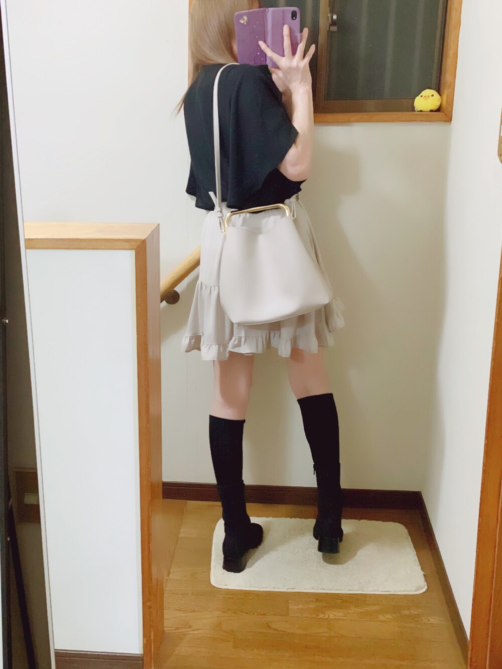 ブラック系のブーツ、ホワイト系のハンドバッグ、グレー系のその他パンツを着用したレディースの夏コーディネートの2枚目の写真