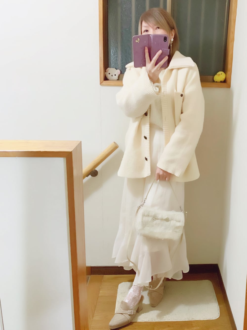 ホワイト系のその他アウター、ホワイト系のニット/セーター、ホワイト系のスカートを着用したレディースの冬コーディネートの3枚目の写真