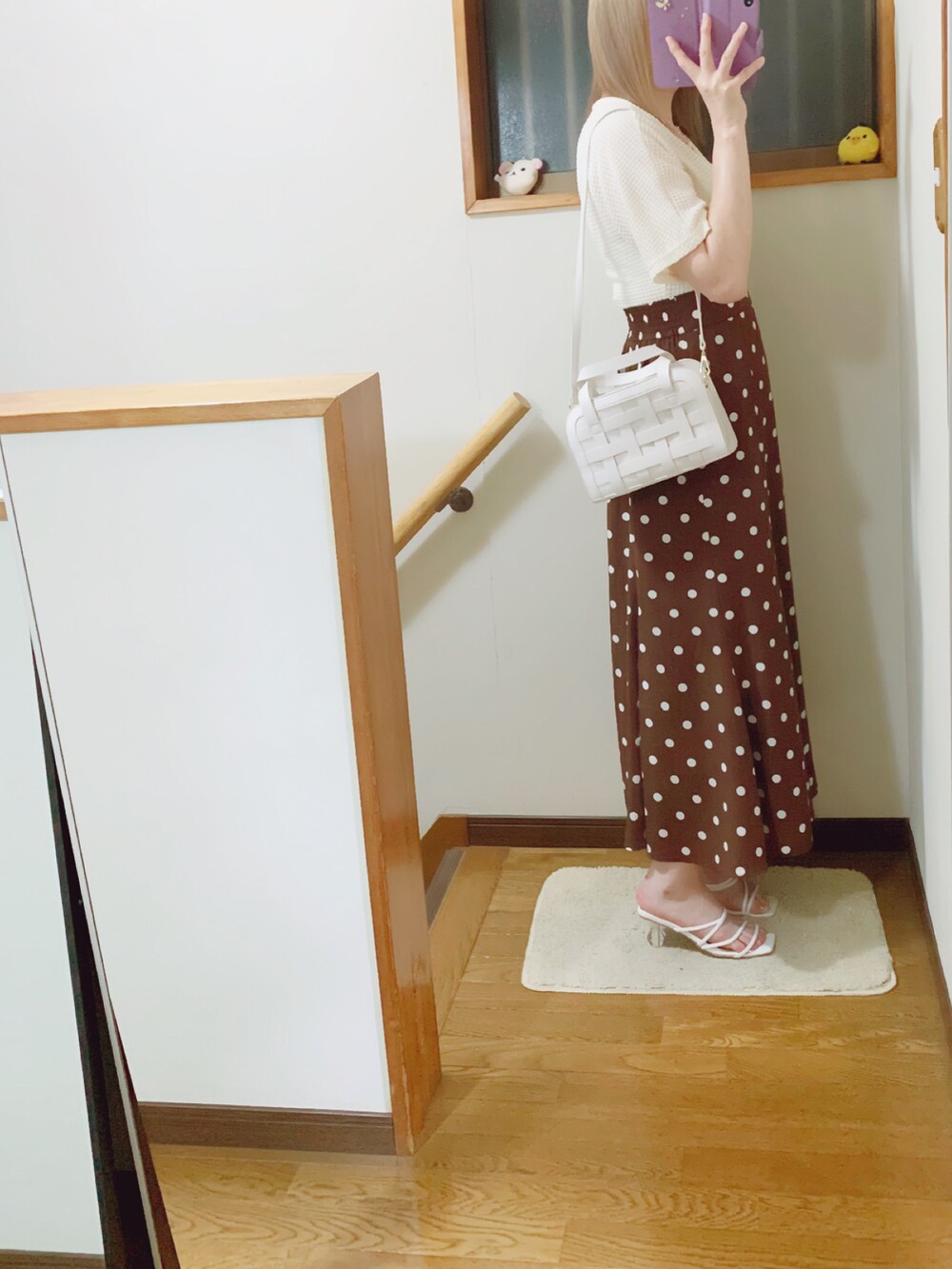 ホワイト系のサンダル、ブラウン系のスカート、ホワイト系のショルダーバッグを着用したレディースの夏コーディネートの2枚目の写真