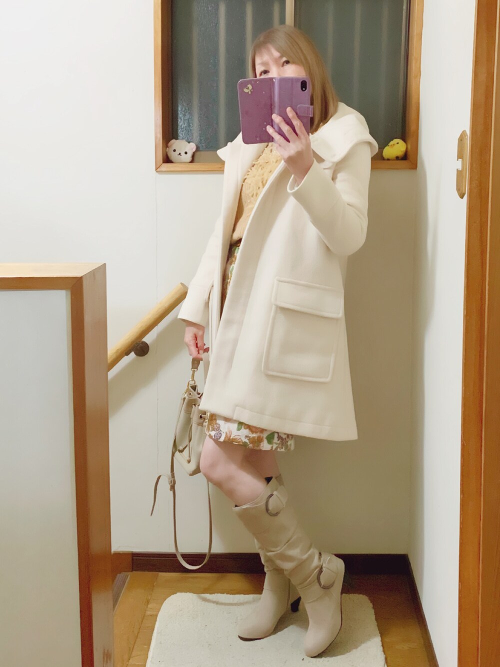ベージュ系のニット/セーター、ベージュ系のショルダーバッグ、ホワイト系のジャケット/アウターを着用したレディースの冬コーディネートの3枚目の写真