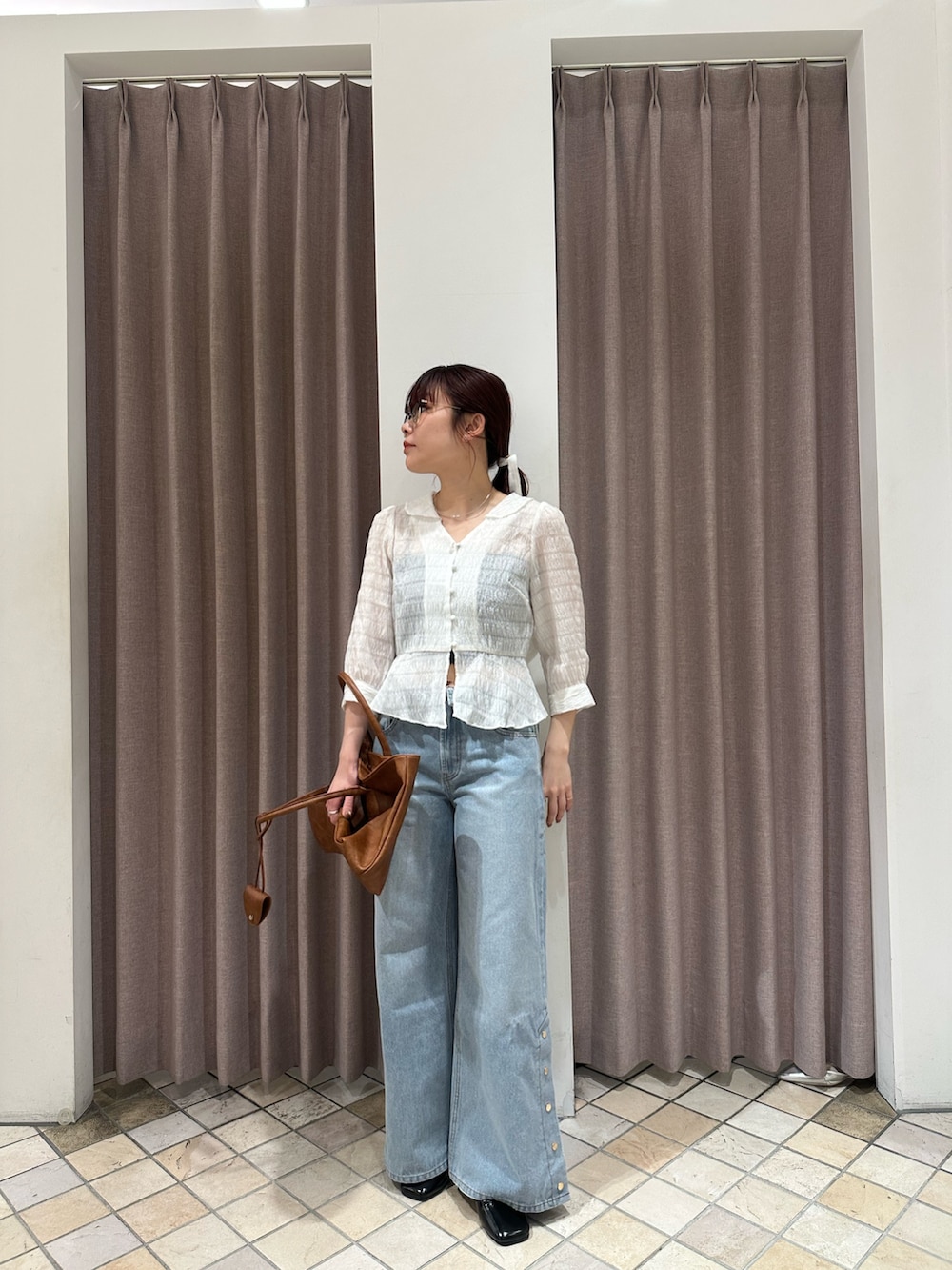 ホワイト系のシャツ/ブラウス、ブルー系のデニムパンツ、ブラック系のパンプスを着用したレディースの春コーディネートの2枚目の写真