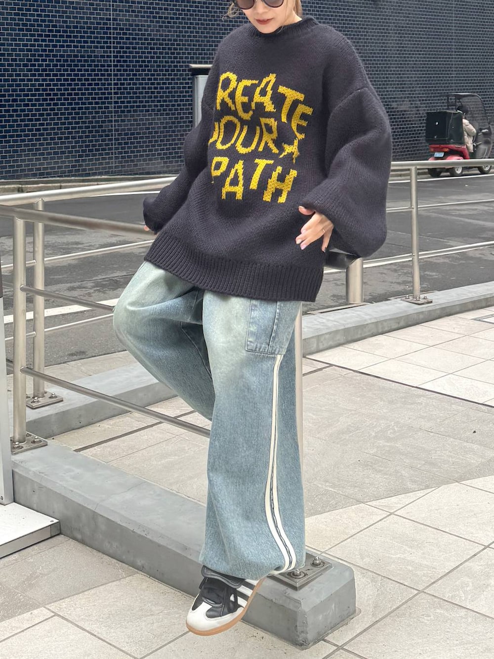 ブルー系のデニムパンツ、ブルー系のニット/セーターを着用したレディースの秋コーディネートの2枚目の写真