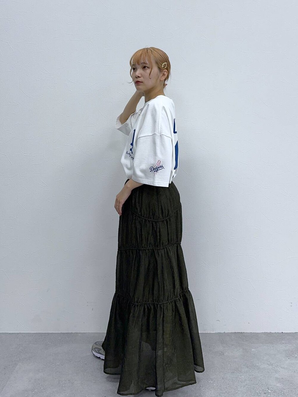 グリーン系のスカート、ホワイト系のTシャツ/カットソーを着用したレディースの夏コーディネートの4枚目の写真