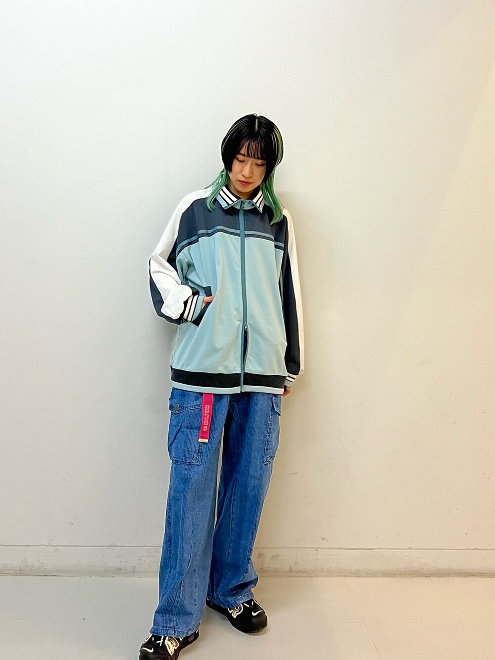 ブルー系のジャージ、ブルー系のデニムパンツ、ピンク系のベルトを着用したレディースの春コーディネートの2枚目の写真