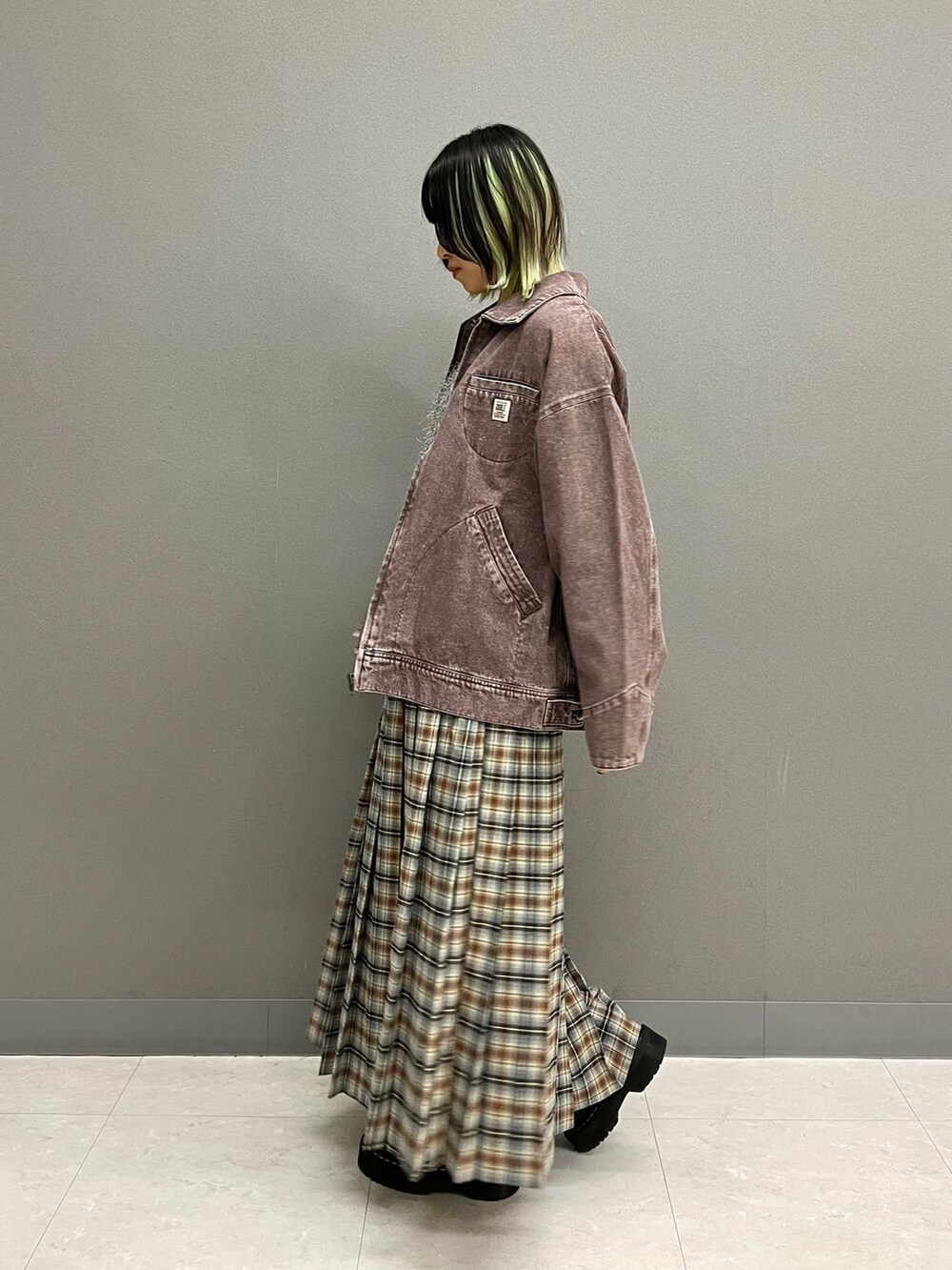 ブラウン系のブルゾン、ホワイト系のTシャツ/カットソー、グレー系のベストを着用したレディースの秋コーディネートの4枚目の写真