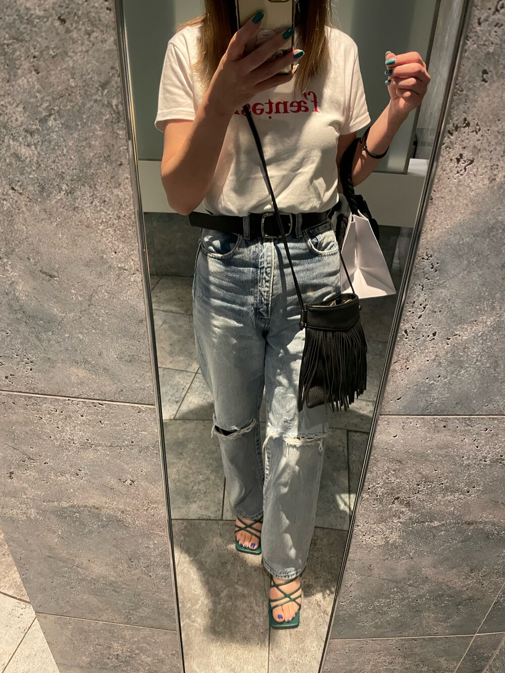 ホワイト系のTシャツ/カットソー、ブルー系のデニムパンツを着用したレディースの春コーディネートの2枚目の写真