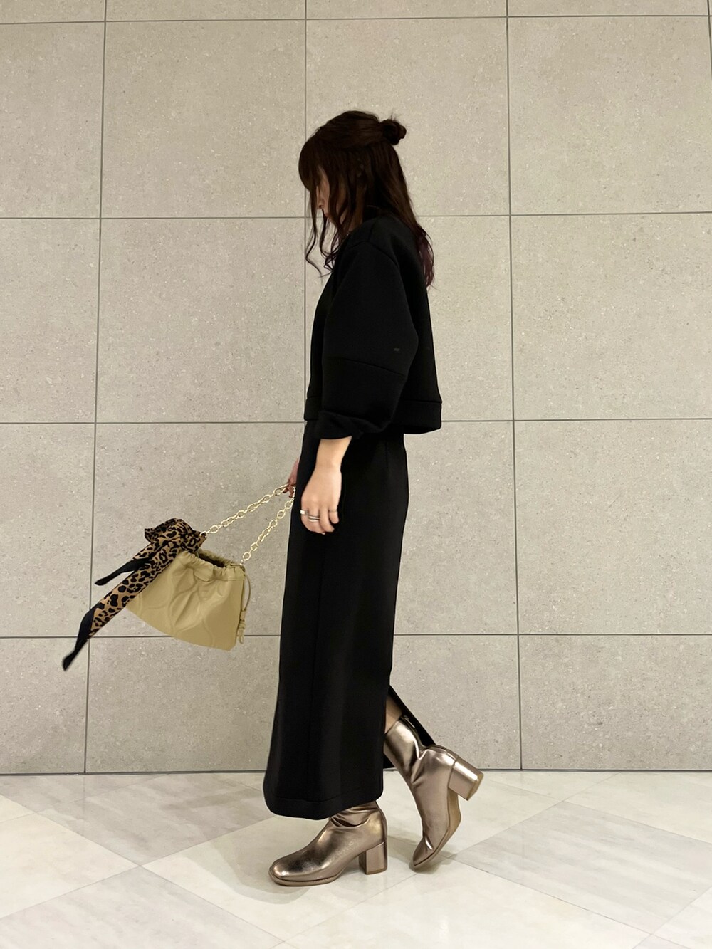 ブラック系のTシャツ/カットソー、ブラック系のスカート、その他のブーツを着用したレディースの冬コーディネートの3枚目の写真