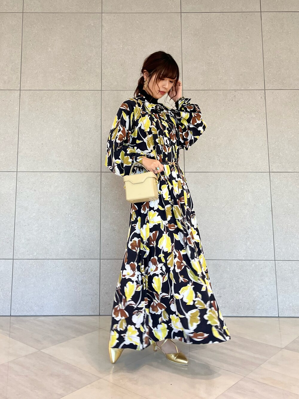ブラック系のワンピース、ゴールド系のパンプス、ブラック系のTシャツ/カットソーを着用したレディースの春コーディネートの2枚目の写真