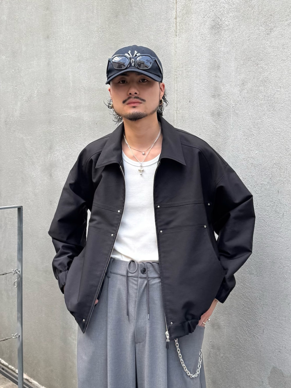 ブラック系のブルゾン、グレー系のスラックスを着用したメンズの秋コーディネートの4枚目の写真