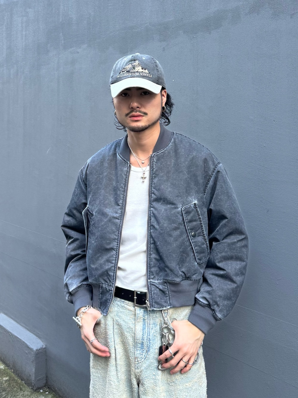 グレー系のMA-1、ブルー系のデニムパンツ、ブラック系のその他シューズを着用したメンズの秋コーディネートの4枚目の写真