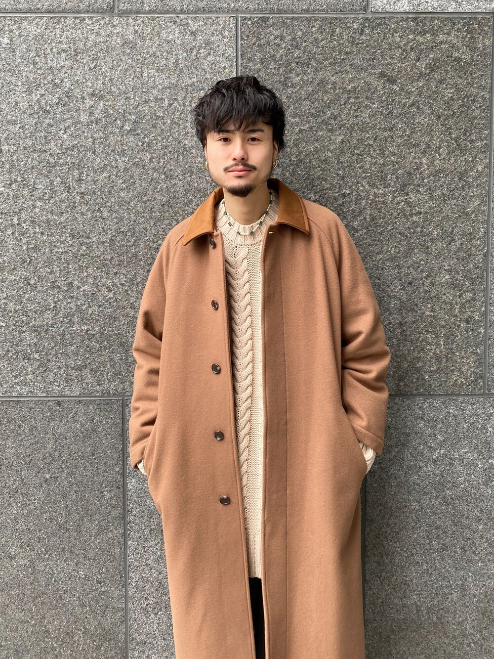 イエロー系のその他アウター、ホワイト系のニット/セーター、グレー系のスラックスを着用したメンズの冬コーディネートの5枚目の写真