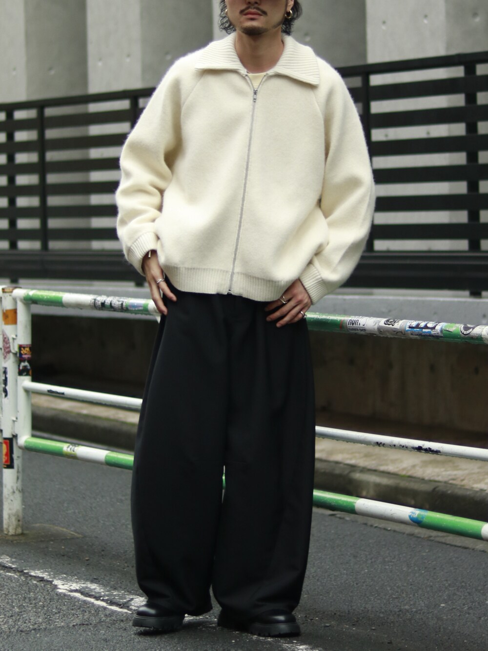 ホワイト系のニット/セーター、ブラック系のパンツ、ブラック系のブーツを着用したメンズの秋コーディネートの2枚目の写真