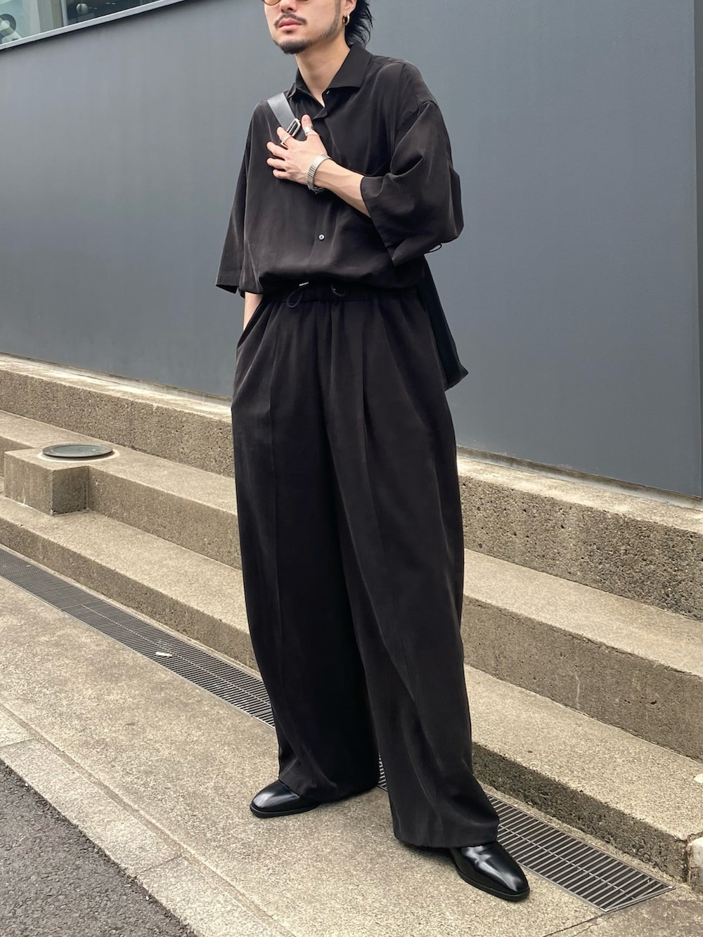 ブラック系のシャツ/ブラウス、ブラック系のスラックスを着用したメンズの春コーディネートの2枚目の写真