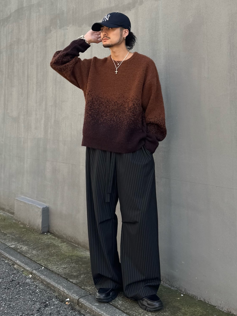 ブラウン系のニット/セーター、ブラック系のローファー、ブラック系のその他パンツを着用したメンズの冬コーディネートの2枚目の写真