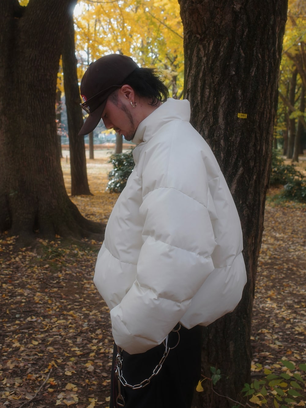 ホワイト系のダウンジャケット/コート、ブラック系のスラックスを着用したメンズの冬コーディネートの5枚目の写真