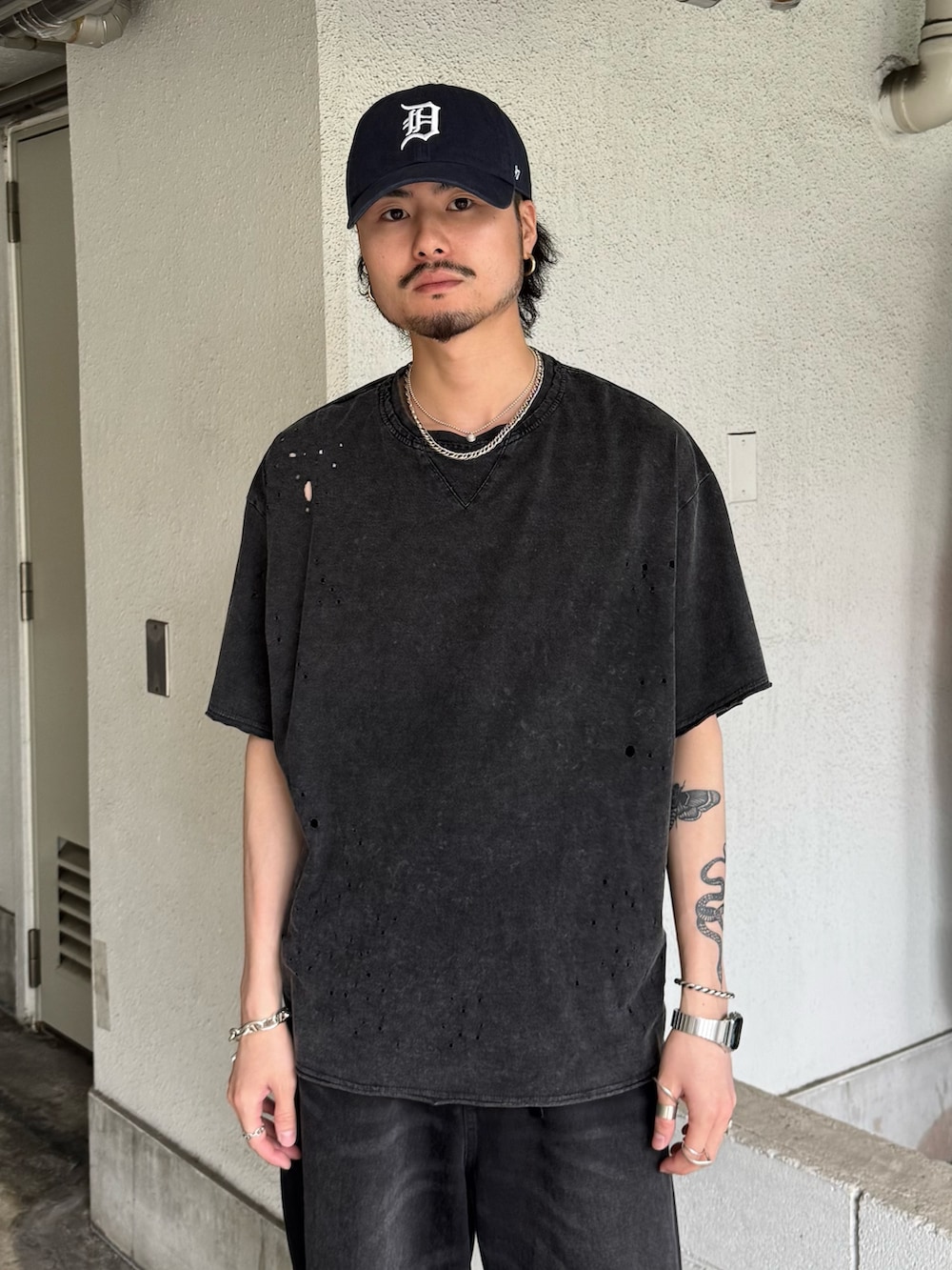 グレー系のTシャツ/カットソー、ブラック系のデニムパンツを着用したメンズの夏コーディネートの3枚目の写真