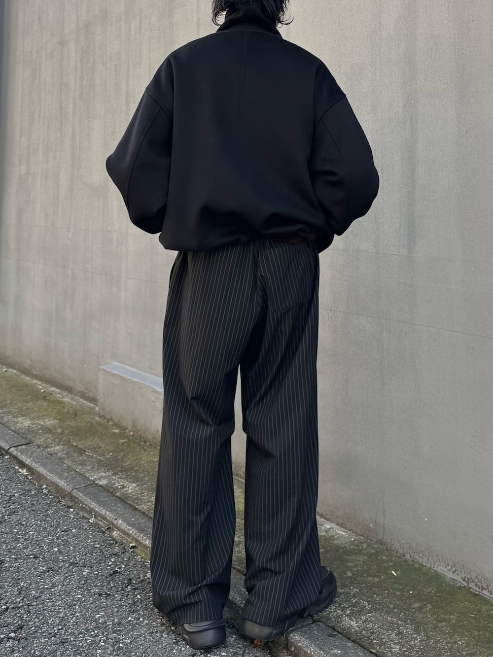 ブラウン系のニット/セーター、ブラック系のその他パンツ、ブラック系のローファーを着用したメンズの秋コーディネートの5枚目の写真