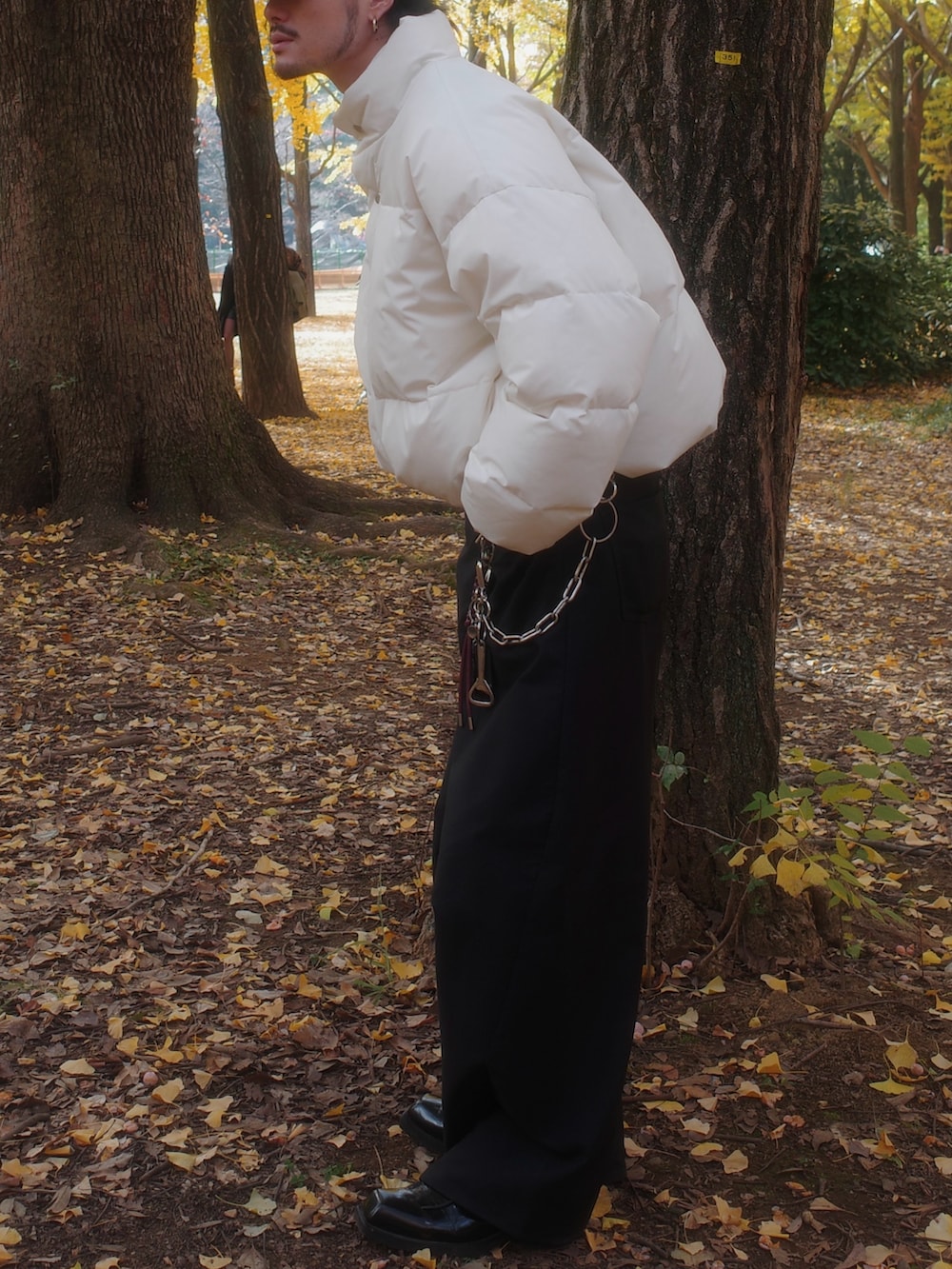 ホワイト系のダウンジャケット/コート、ブラック系のスラックスを着用したメンズの冬コーディネートの3枚目の写真