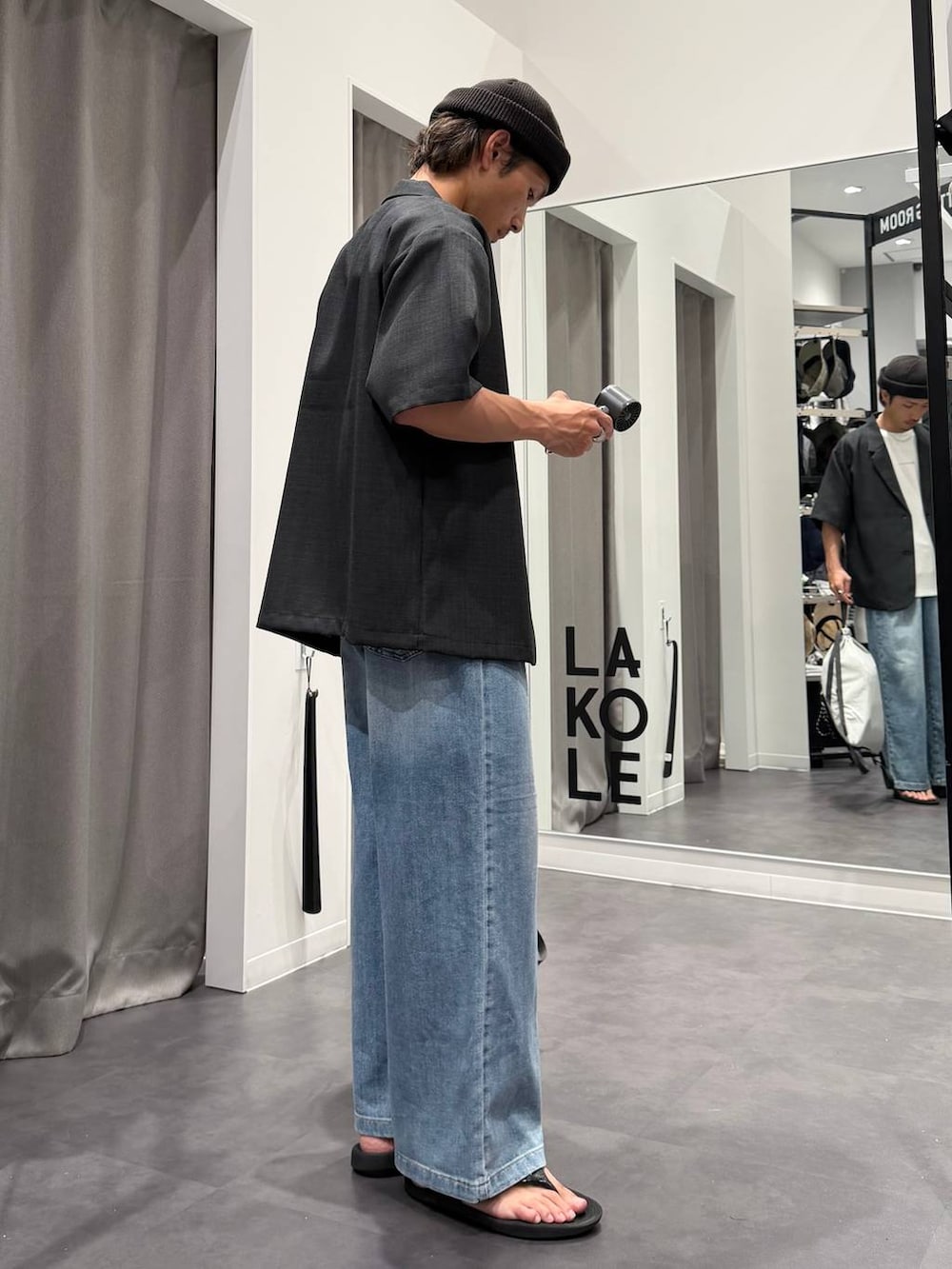 ブラック系のサンダル、ホワイト系のTシャツ/カットソー、ブルー系のデニムパンツを着用したメンズの春コーディネートの2枚目の写真