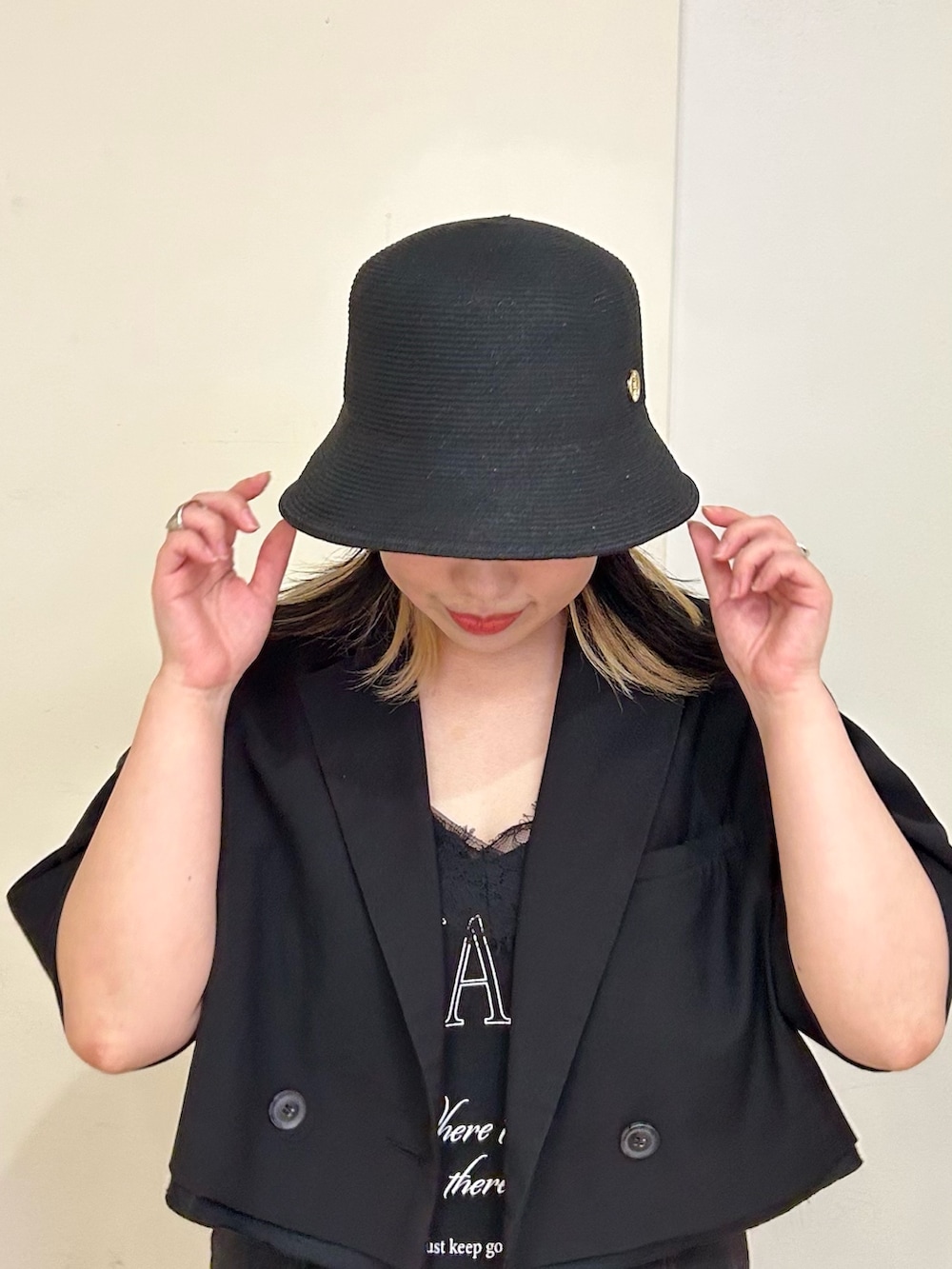 ブラック系のハットを着用したレディースの夏コーディネートの2枚目の写真