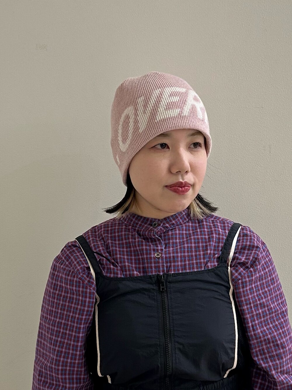ピンク系のニットキャップ/ビーニーを着用したレディースの冬コーディネートの2枚目の写真