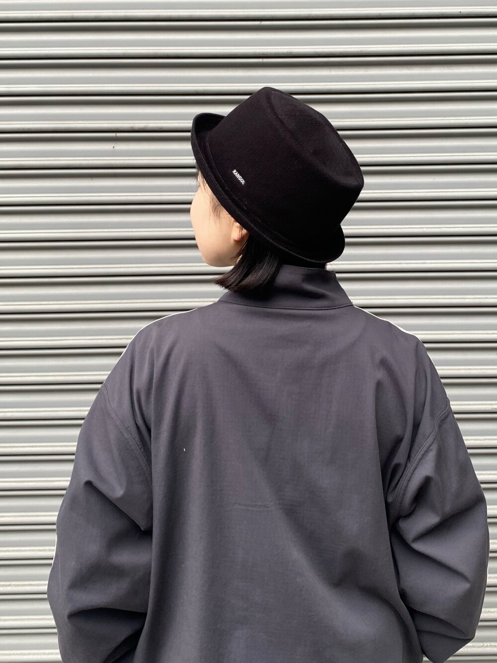 ブラック系のハットを着用したレディースの春コーディネートの3枚目の写真