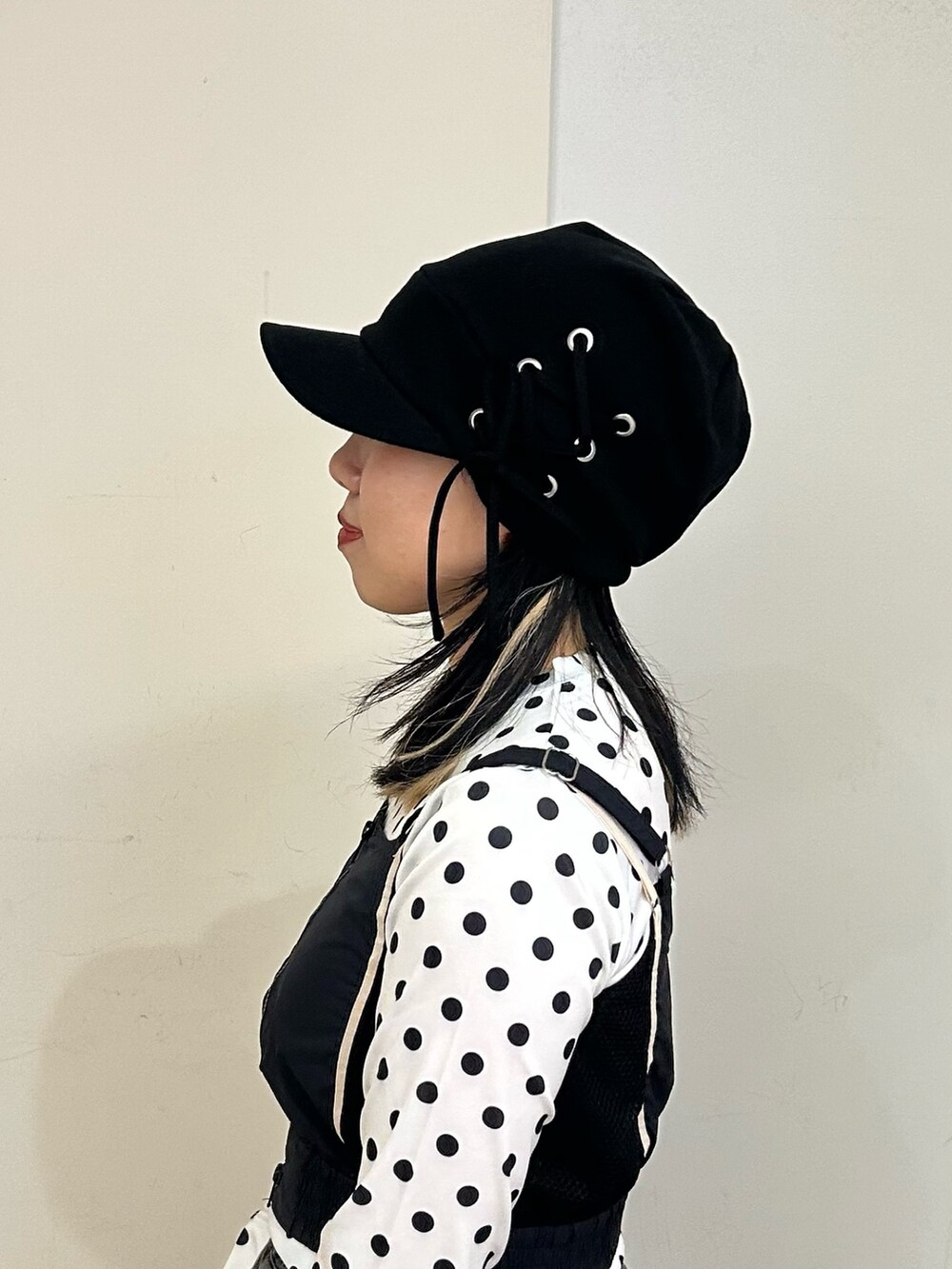 ブラック系のキャップを着用したレディースの春コーディネートの3枚目の写真