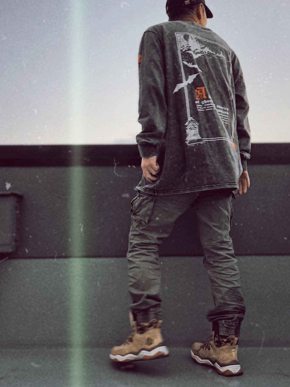 グレー系のTシャツ/カットソー、グリーン系のカーゴパンツ、ベージュ系のスニーカーを着用したメンズの秋コーディネートの2枚目の写真