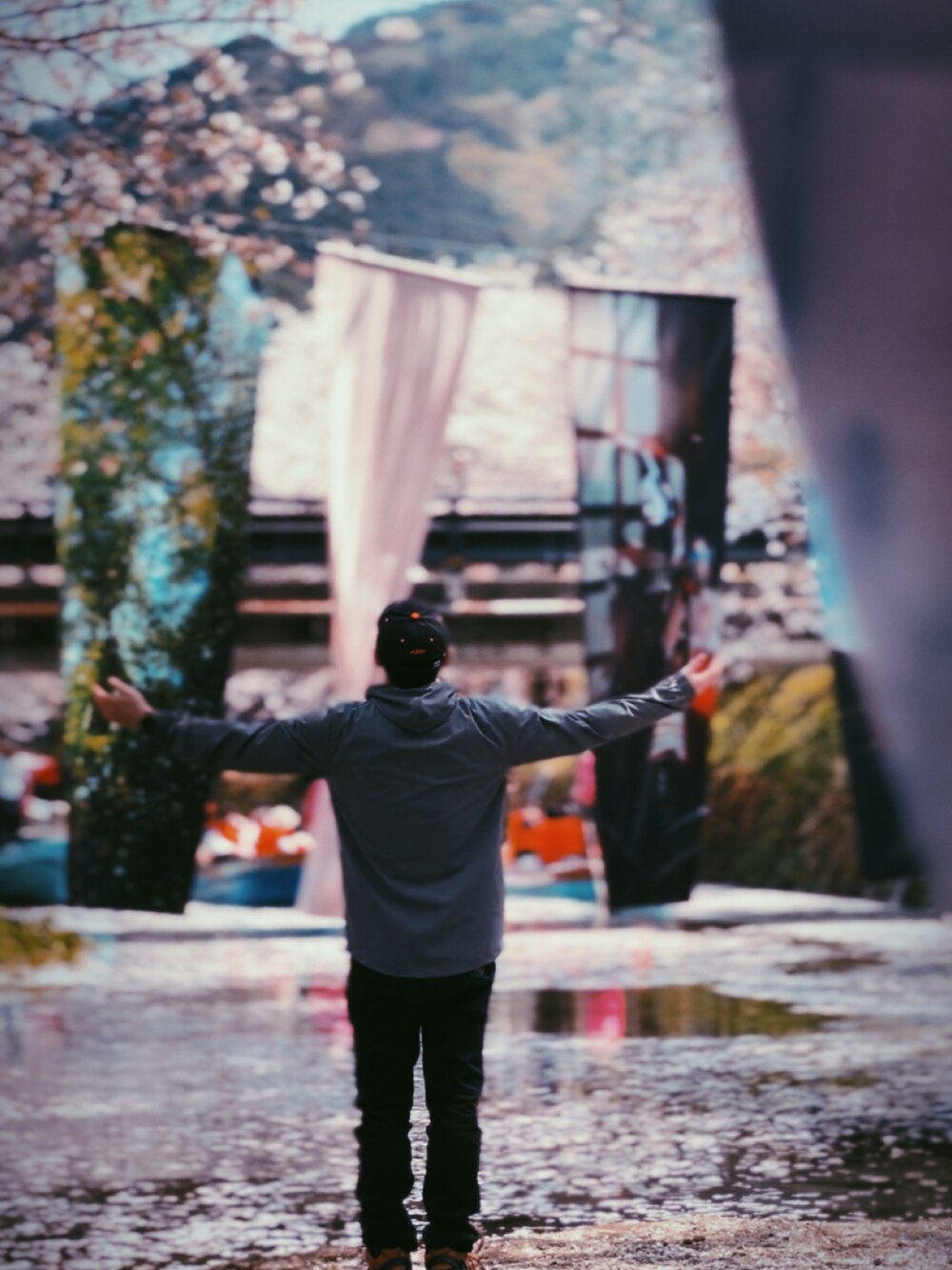 グレー系のパーカー、ブラウン系のスニーカー、ブラック系のキャップを着用したメンズの春コーディネートの2枚目の写真